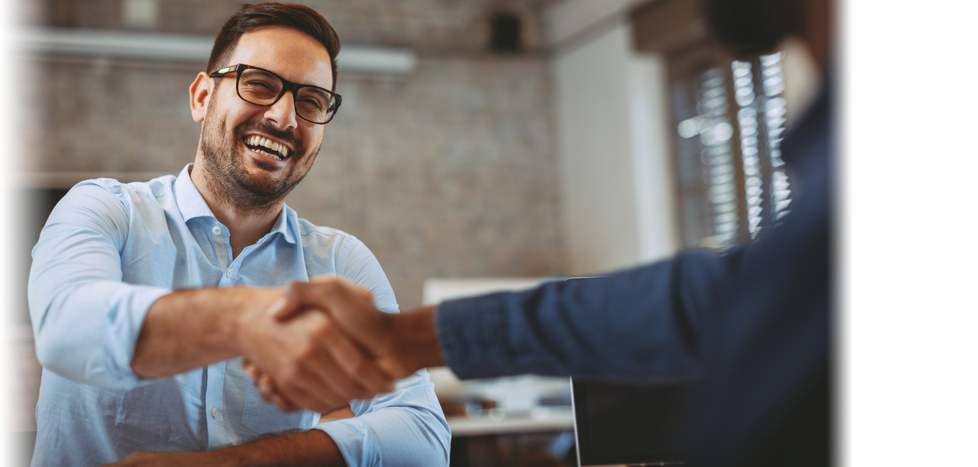 smiling man in glasses shaking hand